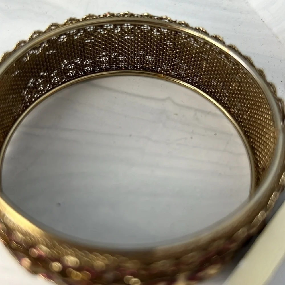 Gold filigree bangle with red accents